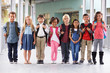 © Monkey Business - Group of elementary school kids standing in school corridor