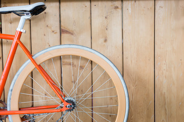 Wall Mural - bicycle parked with wood wall, close up image part of bicycle