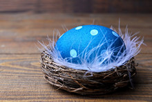 Blue Easter Egg In The Nest With Feathers