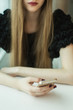 © yuliasverdlova - woman with phone at the table