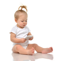 Happy child baby toddler sitting smiling and playing with mobile