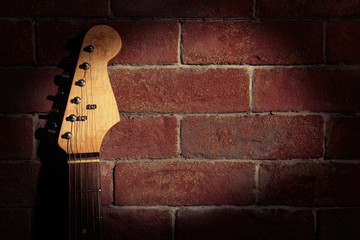 Poster - Guitar's fingerboard on brick wall background