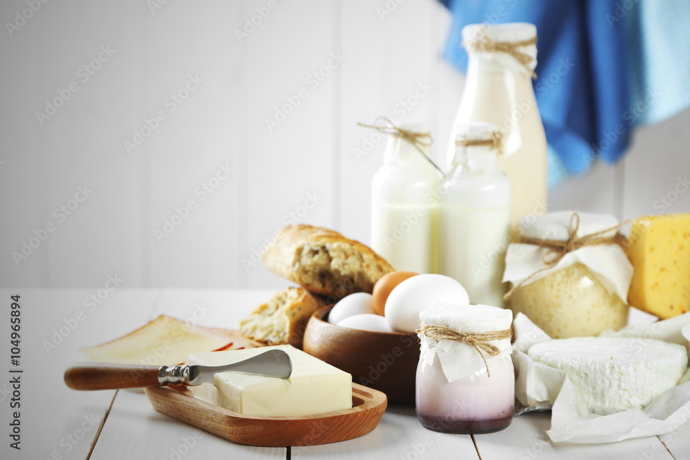 Set of fresh dairy products on white wooden table