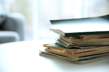 Poster - Pile of old books on white table