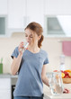 © Africa Studio - Young woman drinking water from glass in the kitchen