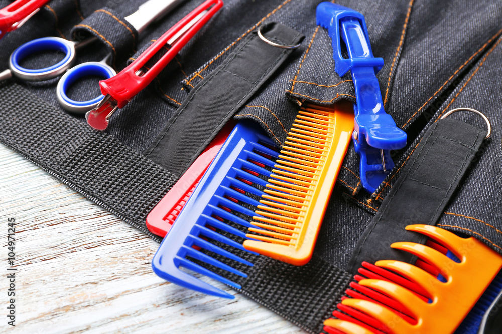 Professional hairdressing equipment in black case on white wooden table background