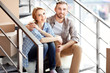 © Africa Studio - Happy young couple with moving boxes on stairs indoors