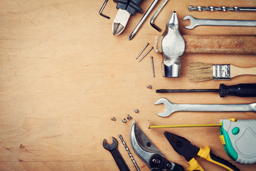 Working tools on wooden rustic background, top view