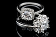 Luxury jewellery. White gold or silver engagement rings with diamonds closeup. Selective focus.