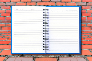 Wall Mural - Blank page of note book on stone wall background.