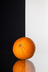 Wall Mural - Single orange isolated on black and white background