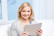 © Syda Productions - happy middle aged woman with tablet pc at home