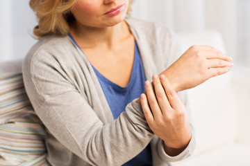 close up of woman with pain in hand at home