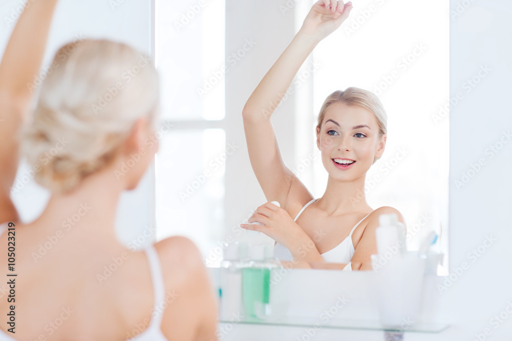 woman with antiperspirant deodorant at bathroom - obrazy, fototapety, plakaty 