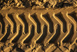 embossed trail excavator tracks on the sand. closeup texture of