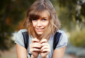 portrait of a beautiful young girl with brown hair on the backgr