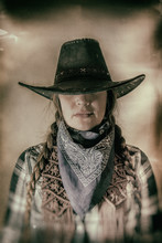 Old West Cowgirl Hat Low Wide. Old West Cowgirl With Hat Low Blocking Eyes, Edited In Vintage Film Style.