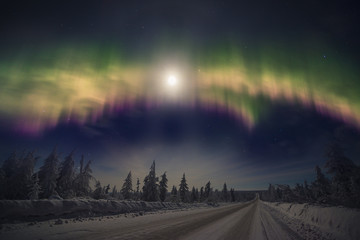 winter night landscape with forest, road, snow and northern light over the scene