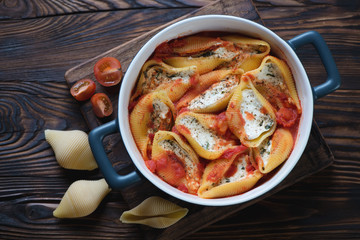 Wall Mural - Conchiglioni with cottage cheese stuffing in a baking dish