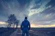 © Giorgio Pulcini - Man under a cloudy sky in the country watching the sunset