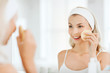 © Syda Productions - young woman washing face with sponge at bathroom