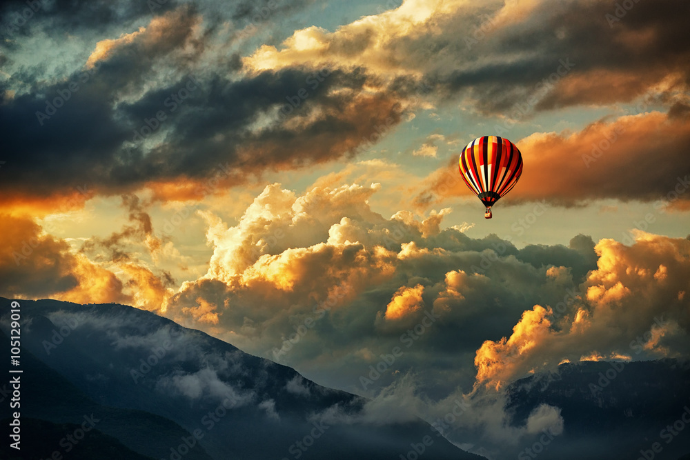 Hot air balloon in a storm clouds Stock Photo | Adobe Stock