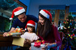 © torwaiphoto - Asian family opening a gift box on christmas day happy