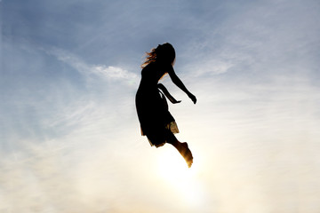 silhouette of woman rising into heaven