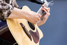 Woman's Hands Playing Acoustic Guitar Closeup