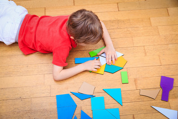 little boy playing with puzzle, early education