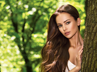 portrait of the young beautiful woman with long hairs. outdoors