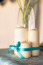 White Candles With A Blue Tape