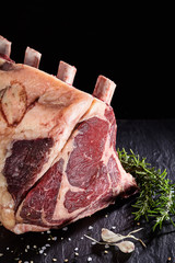 raw cote de boeuf ribs over black background