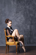 © Acronym - Young ballerina sitting in a retro armchair