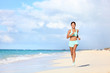 © Maridav - Happy fit female runner running on sand during summer travel vacation on tropical beach. Asian woman jogging doing cardio training exercising for weight loss. Happiness and wellbeing concepts.