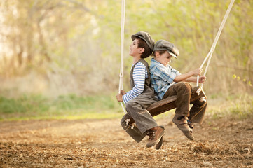 Children on swings sunny summer day