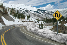 Switchback Road And Sign:  A Sign Warns Of Repeated Sharp Turns Ahead On A Mountain Road In Southwest Colorado.
