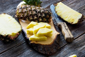 Wall Mural - Pineapple fruit cut on wooden background