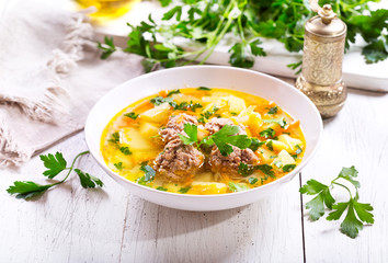 plate of soup with meatballs