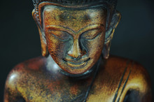 Wooden Bronze Buddha On Black Blurred Background