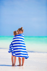 Wall Mural - Adorable little girls wrapped in towel at tropical beach