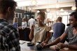 © mavoimages - African woman entrepreneur having a meeting in coffee shop