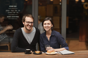 Wall Mural - Smiling couple posing at modern outdoor cafe