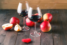 Two Wine Glass And Red Heart On Wooden Table