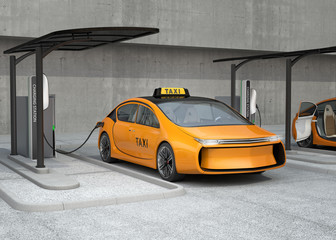 Yellow electric taxi charging in charging station. The charging station supply by solar panel and battery.