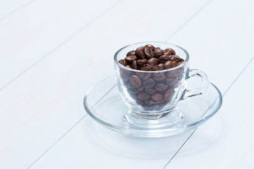 Coffee cup with coffee beans on table