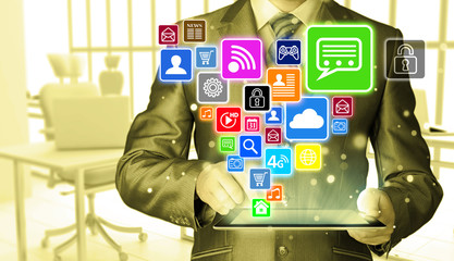 Business man using tablet PC with social media icon set