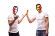 © F8  \ Suport Ukraine - France vs Romania. Football fan of  Romania national teams show red card to France fan on white background.  European  football fans concept.