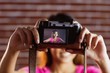 © WavebreakmediaMicro - Smiling asian woman taking picture with camera