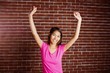 © WavebreakmediaMicro - Smiling asian woman raising arms
